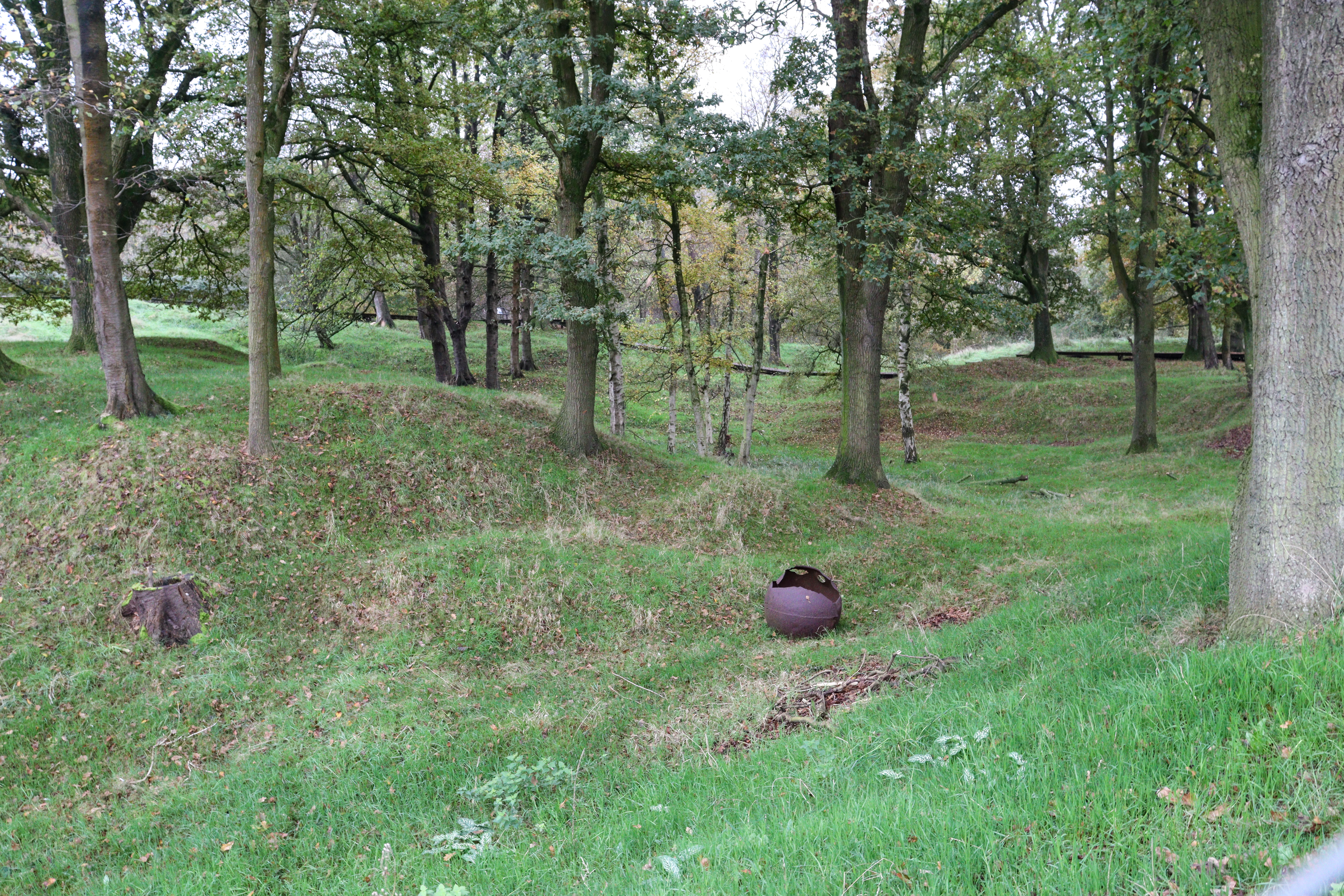 Shell of an exploded mine, lying on the grass