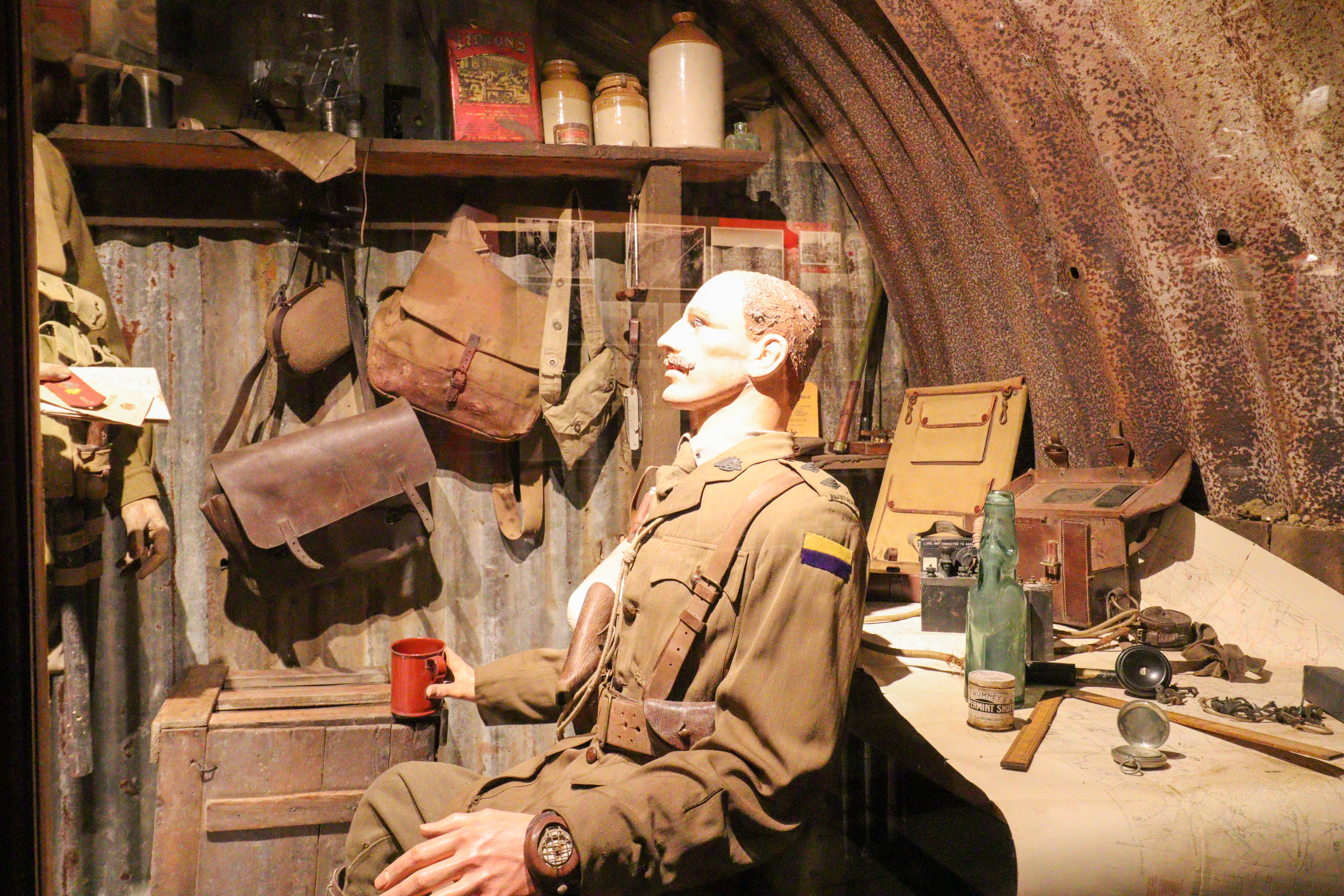 German soldier sitting and looking at another soldier who is almost out of shot but standing