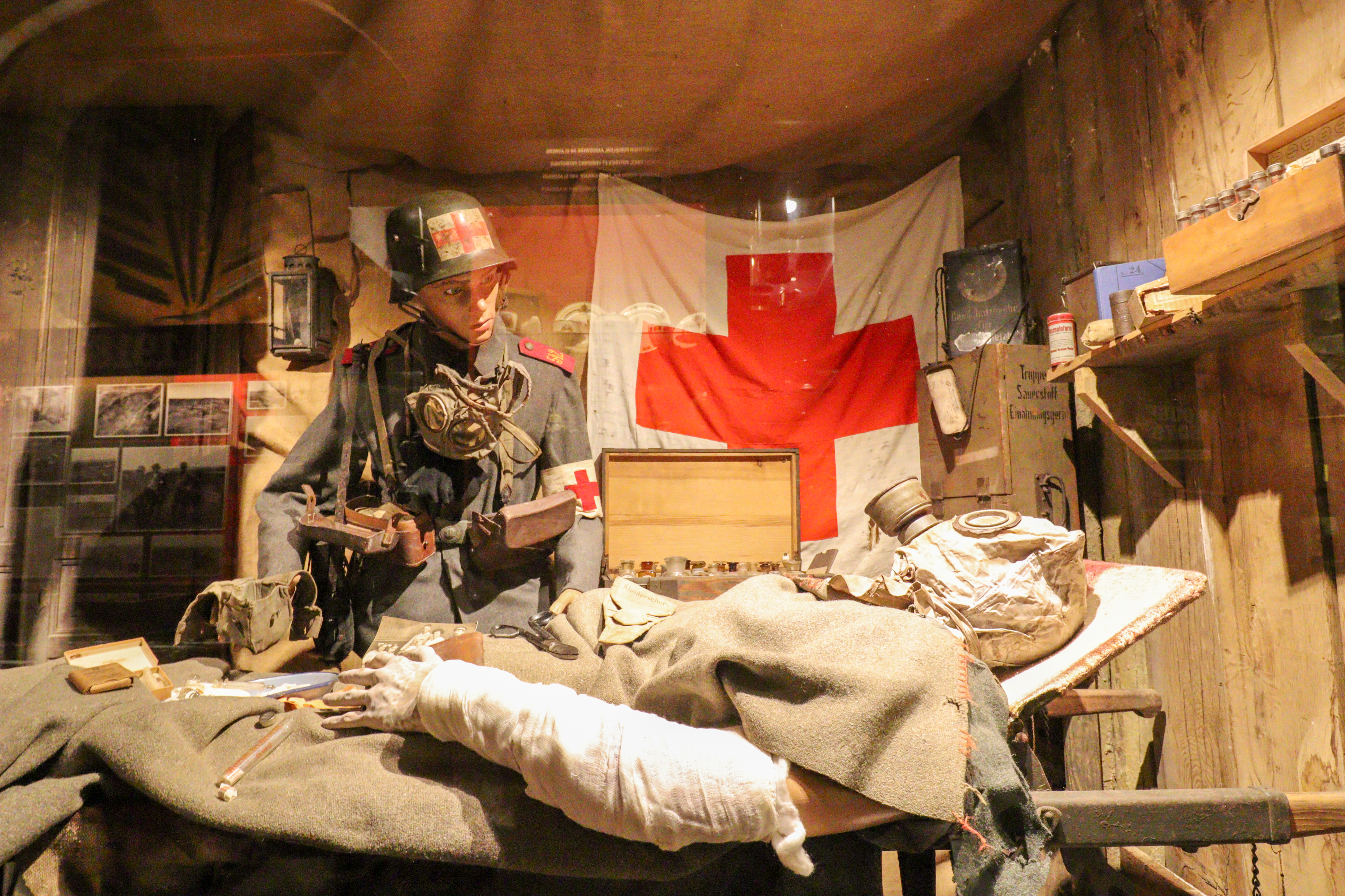 Injured soldier wearing a gas mask, lying on a bed