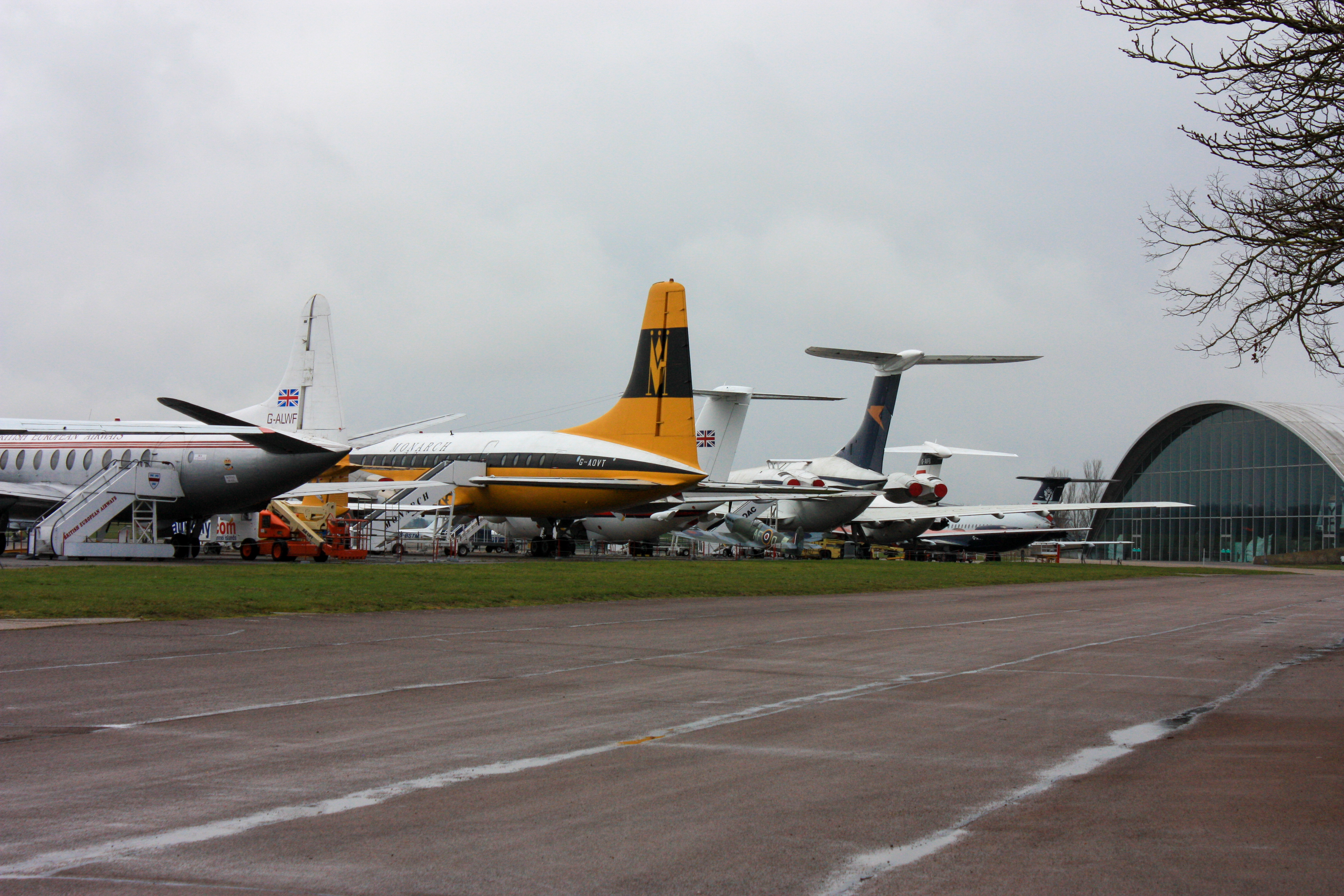 Photo of several large aeroplanes on display, with the American Museum in the distance.