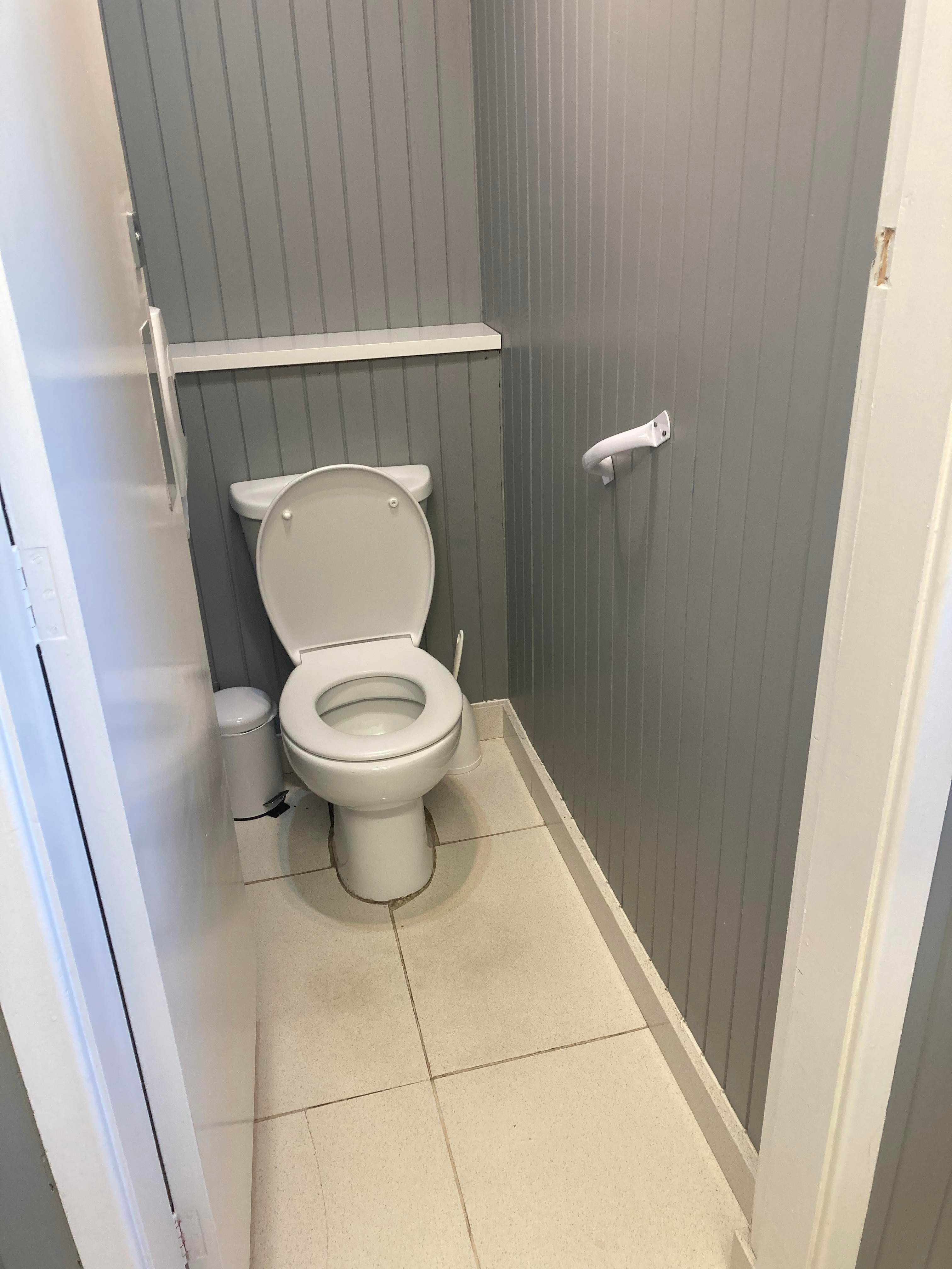 A single cubical ladies toilet with barely enough room to stand and close the door but certainly not enough for a wheelchair. There is a grab rail on the wall next to the toilet.