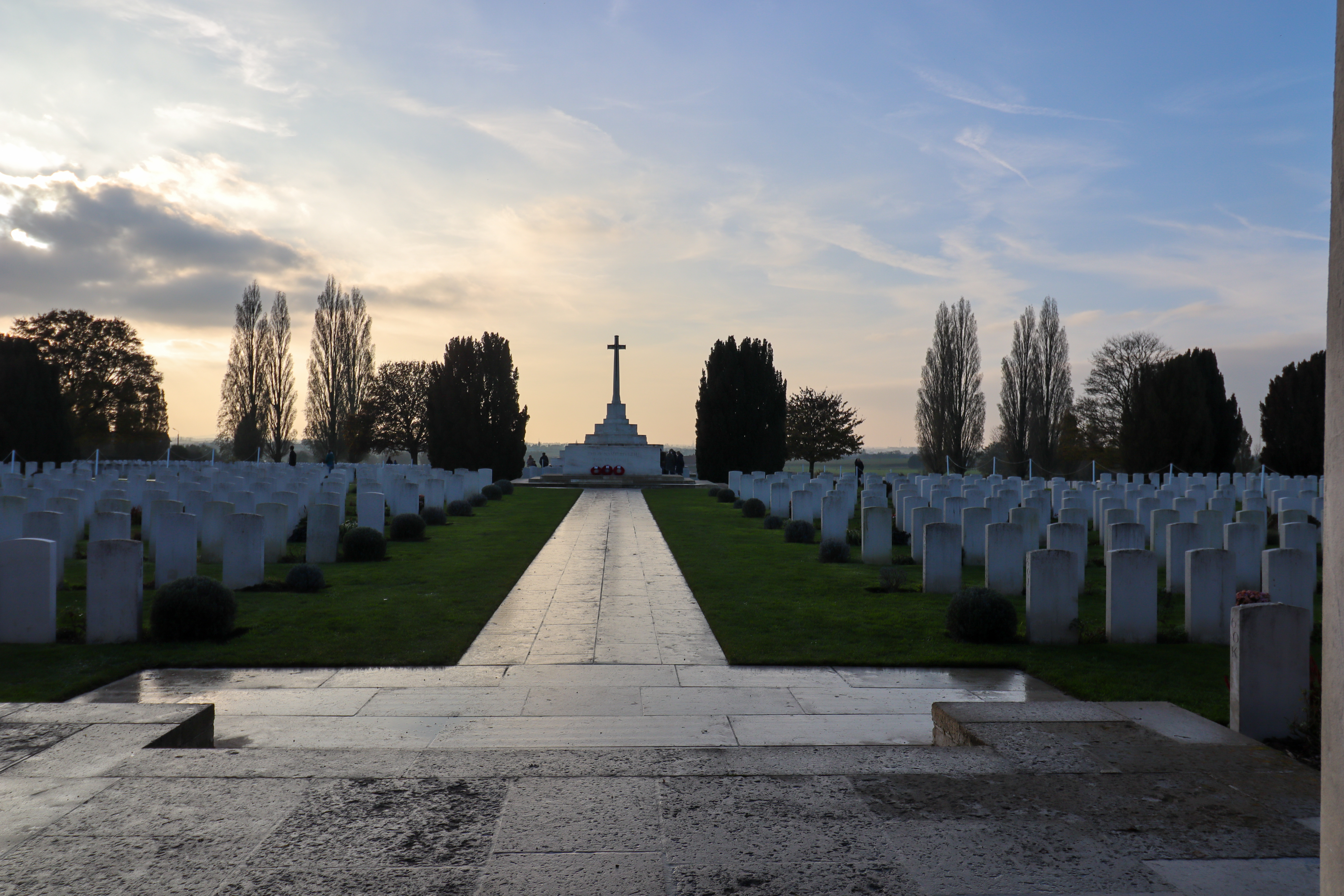 Path through the centre of the cemetery with a large cross shaped memorial in the middle