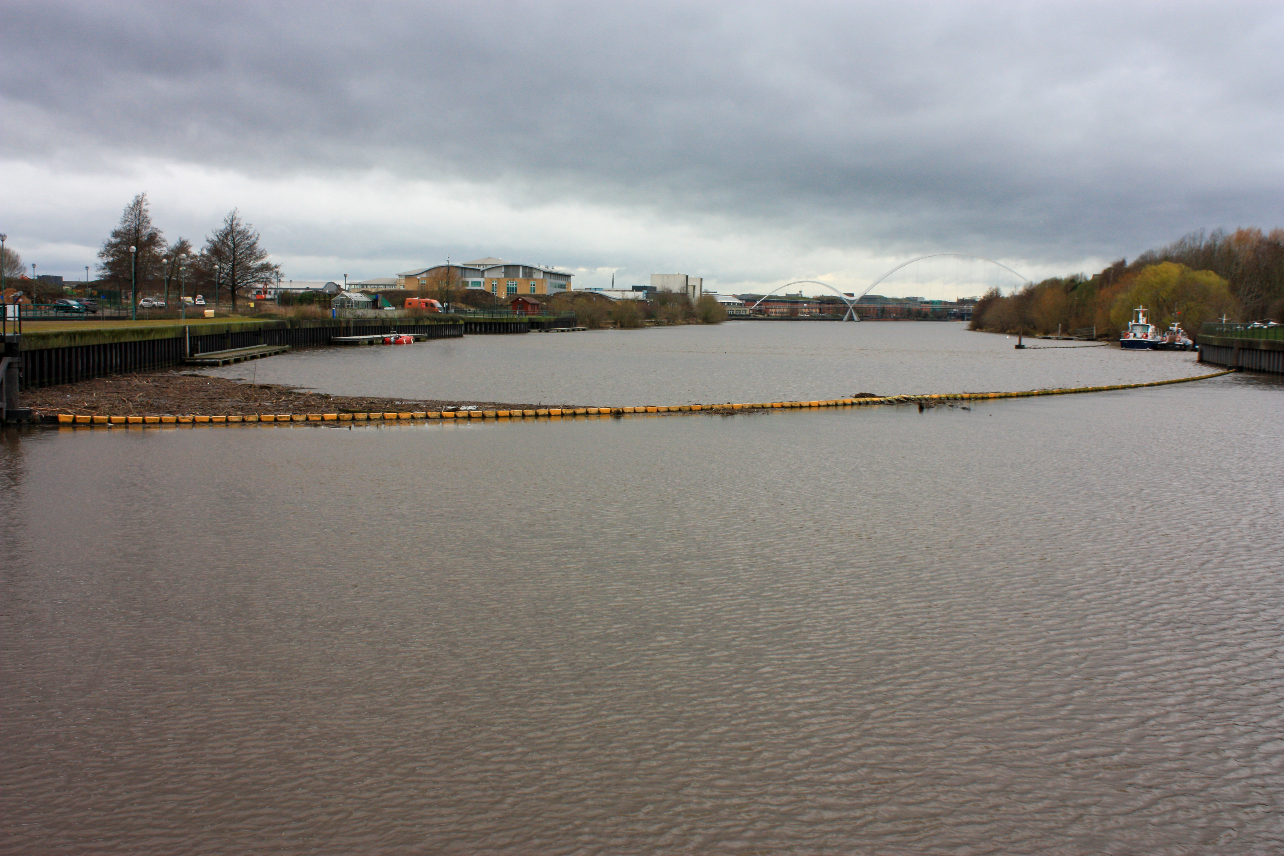 Barrier across a river to prevent boats from going that way.